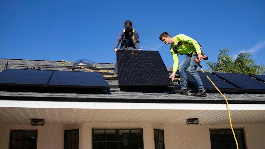 Rooftop solar panels being installed on a home