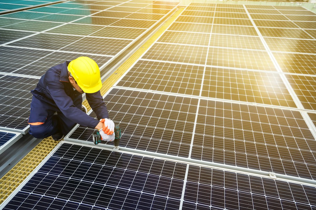 AGEMS technician installing solar panels